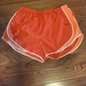Orange Nike running shorts